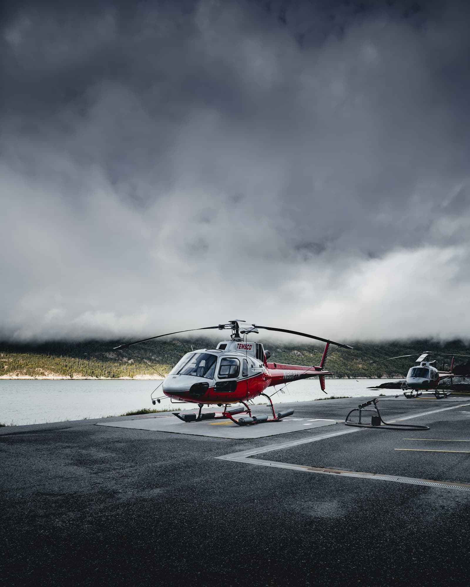 Helicopters parked on a helipad