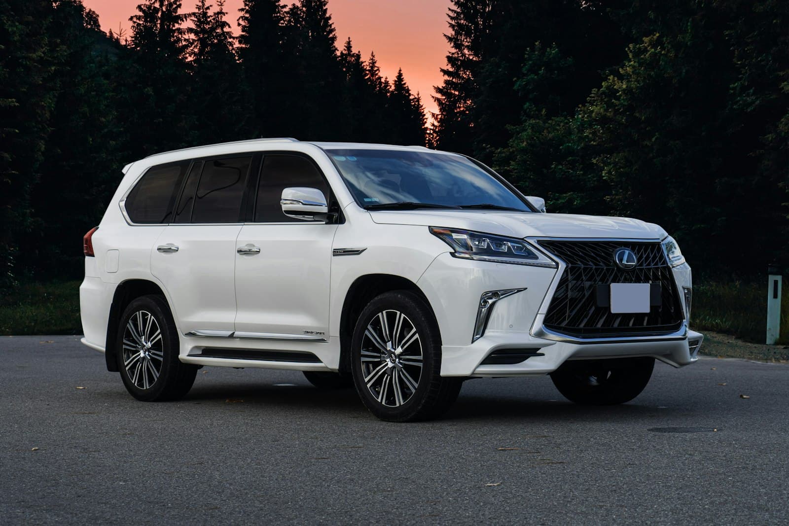 White Lexus LX against a sunset sky